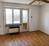 A room in a 3-room apartment with a wood-patterned floor and large windows.