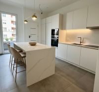 A kitchen with an island, light furniture, and pendant lights, in a 4-room apartment.
