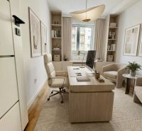 A study in a 4-room apartment with a wooden decor floor and comfortable furniture.
