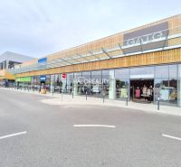 Shopping center with glass displays and a modern wooden facade in BA - Podunajské Biskupice.