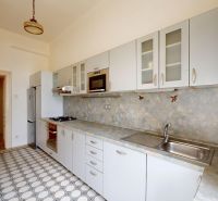 A kitchen in a 4-room apartment with tiles and a kitchen unit.