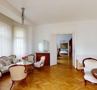 Living room with antique furniture and wood-patterned flooring in a 4-room apartment.