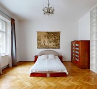 Bedroom in a 4-room apartment with wood-patterned flooring and a bookshelf.