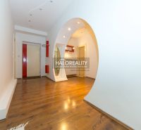 Wooden floor and white arched transition in a 5 or more room apartment.