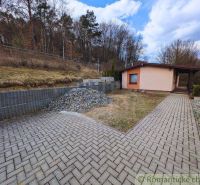 A cottage in Kvakovce near the forest with a path and a pile of gravel.