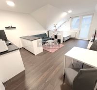 Interior of a 2-room apartment with a wooden decor floor and white furniture.