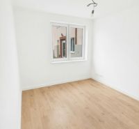 A room with a wooden floor decor and a window in a 2-room apartment.