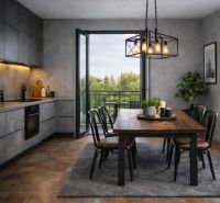A kitchen in a 2-room apartment with a dining table and a view of the balcony.