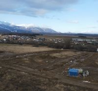 The landscape around Mlynica with a view of development plots and mountain scenery.