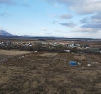 Panorama of development plots in Mlynica, with views of the mountains and rural landscape.