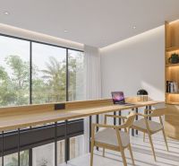 A workspace with wooden decor, large windows, and shelves with books in a villa.