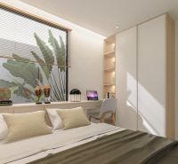 Bright bedroom with a desk, decorations, and a large window.