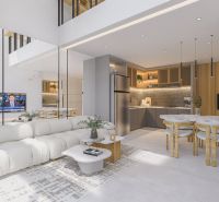 Living room in a villa with a light sofa, kitchen, and dining table.
