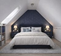 A slanted roof bedroom in a 2-room apartment with a wooden decor floor and a decorative wall.