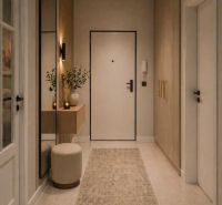 A hallway of a 2-room apartment with modern furniture, a mirror, and decorative elements.