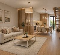 Living room with a kitchenette, sofa, and wooden decor flooring in a 2-room apartment.