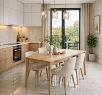A kitchen in a 2-room apartment with a dining table, light furniture, and a balcony.