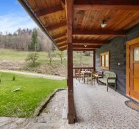 The terrace of a family house in Horná Mariková with wooden furniture and a view of nature.