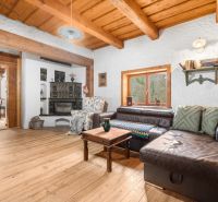 Living room in a family house with a leather sofa and a wooden decor floor.