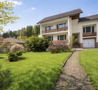 A family house on Čadečka Street in Čadca, surrounded by a beautiful garden and an access walkway.