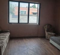 A room with vintage furniture and a wooden decor floor in a family house.