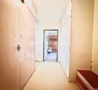 An entrance hall with wooden doors and built-in wardrobes in a 2-room apartment.