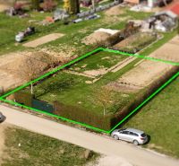 A residential plot in Kľače, bordered by a hedge, with an access road.