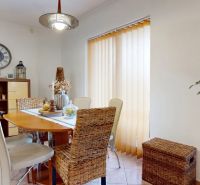 Dining nook with rattan chairs and decorations in a family house.