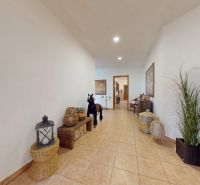 A hallway in a family house with tiles and natural decorations.