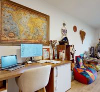 A workspace with a map, wooden floor decor, and comfortable seating, Family house.