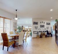 Interior of a family house with a dining table, decorations, and living space.