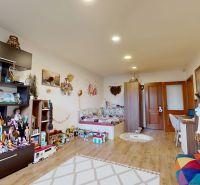 A children's room with lots of toys and shelves, a floor with a wooden decor.