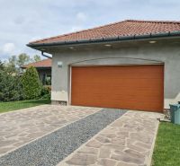A family house in Veľká Paka with a garage, a stone driveway, and a lawn.