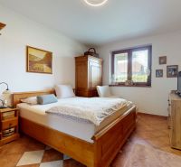 A bedroom with wooden furniture and decorations in a family house.