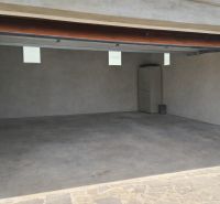 A garage in a family house in Veľká Paka with simple storage space.