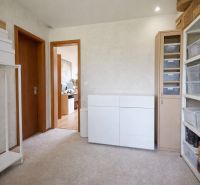 The interior of a family house with built-in wardrobes and carpet, organized and bright.