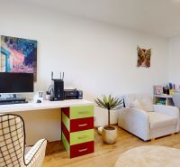 Home office with a desk, chair, and wood-patterned flooring.