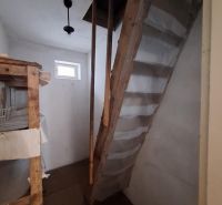 Wooden stairs and shelves in the basement of a family house.