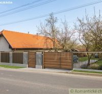 A family house in Stožok with a traditional pitched roof and a wooden gate.