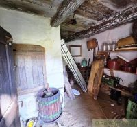 A cottage with historical objects and wooden flooring.