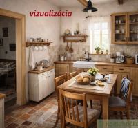 Interior of a cottage with a rustic kitchen, wooden furniture, and a dining table.
