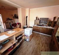 Interior of a family house with wooden decor, cabinets, and rustic furniture.
