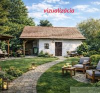 A garden with a cottage in Šahy surrounded by flowers and outdoor seating.
