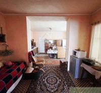 Interior of a family house with carpets, decorative items, and furniture.