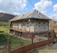 A family house in Zubné with a metal roof, fencing, and a rural surrounding.