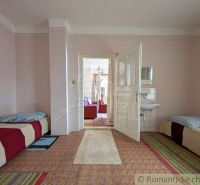Interior of a family house with an entrance hallway, beds, and a sink.