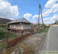 A family house in Zubné with a veranda, next to the main road and close to a hilly area.