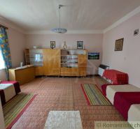 Living room in a family house with antique furniture, multicolored carpets.