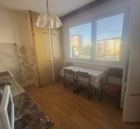 A kitchen in a 3-room apartment with a wooden decor floor, a dining table, and a view.