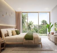 A bright bedroom with large windows, a bed, and wall decorations in a 2-room apartment.